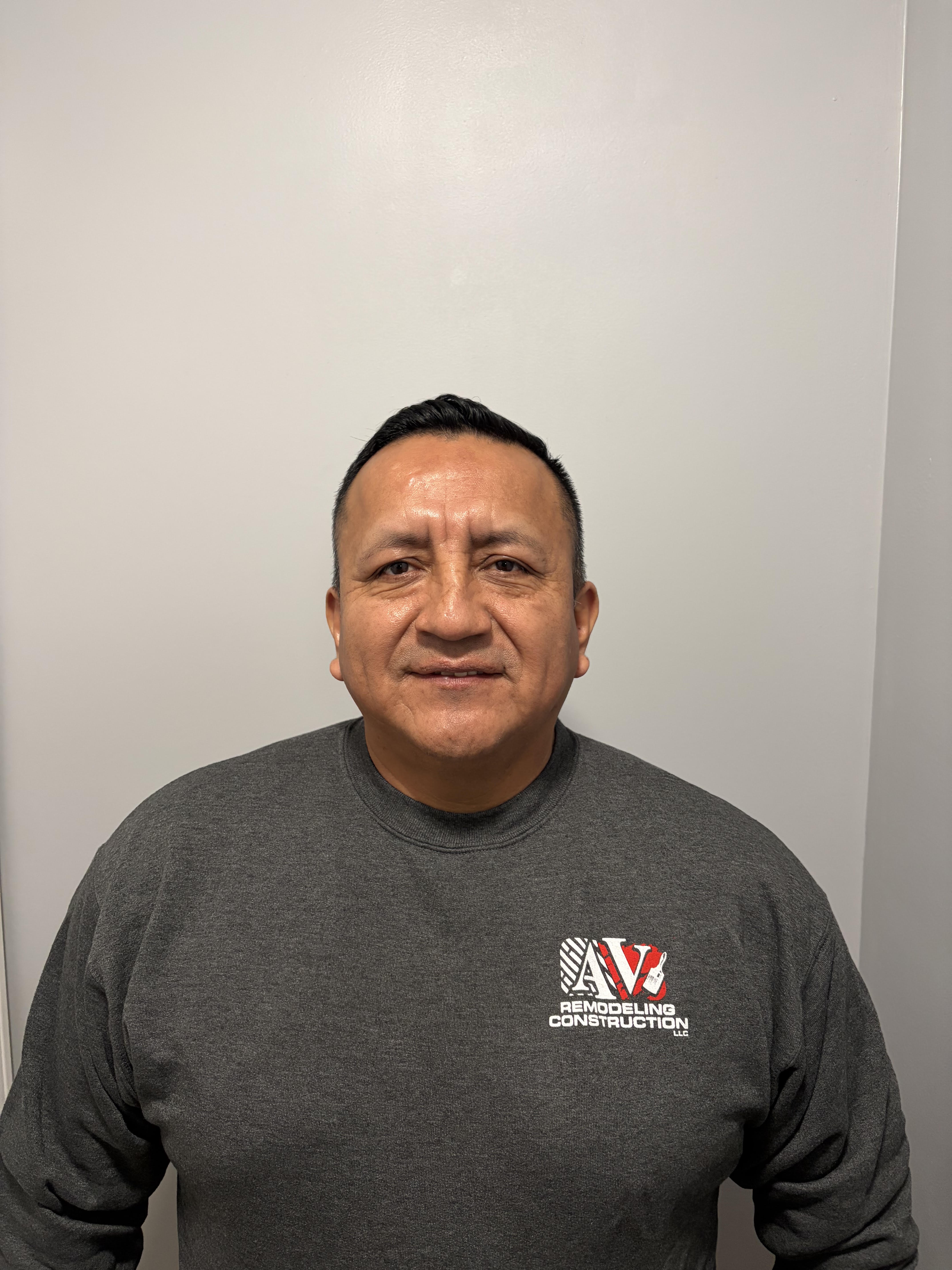 Owner of AV Remodeling Construction LLC wearing the company logo